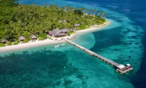 Top 5 must-visit tourist destinations in Sulawesi including Toraja Highlands, Bunaken, Wakatobi, Bantimurung Waterfalls, and Makassar city